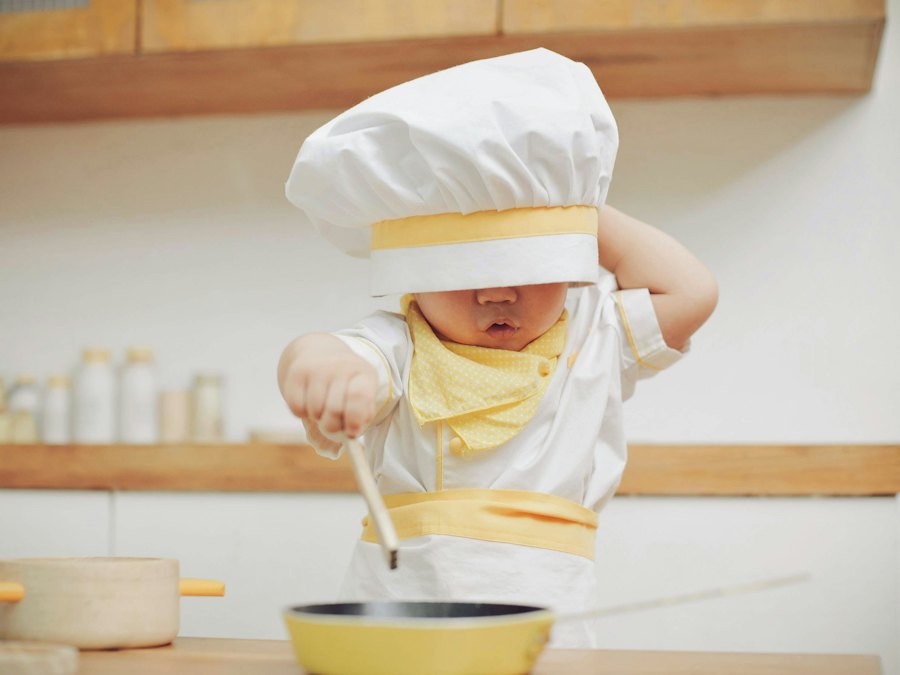 Little chef in a chef hat stirring a pot