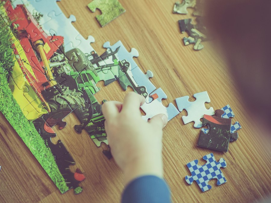 Child putting together a jigsaw puzzle