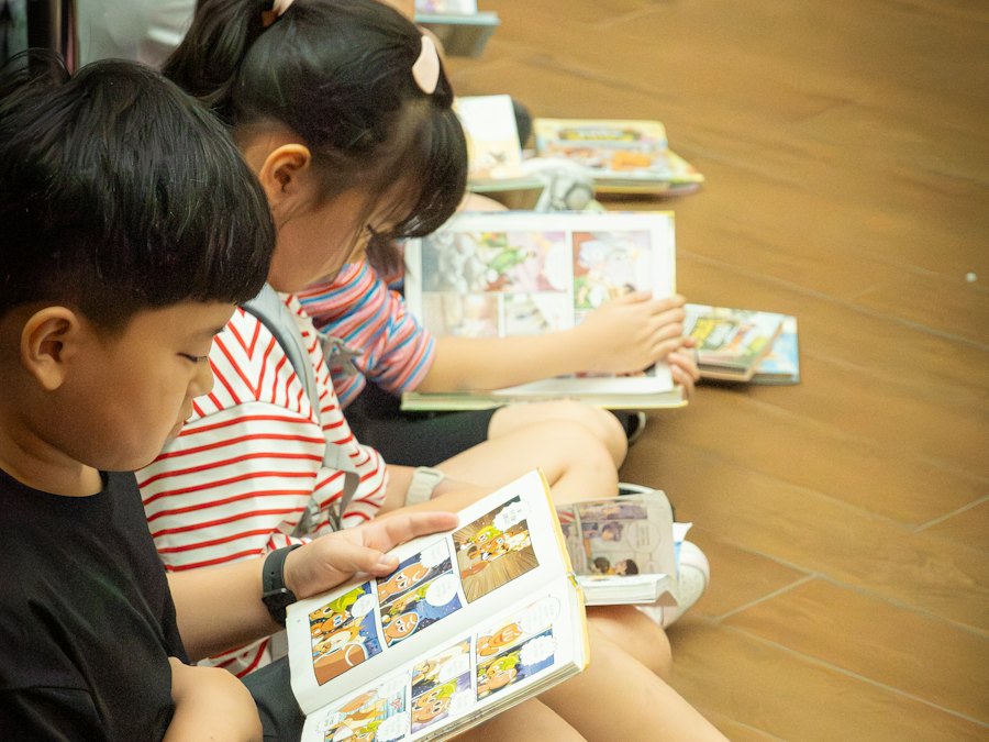 Children reading picture books together on the floor
